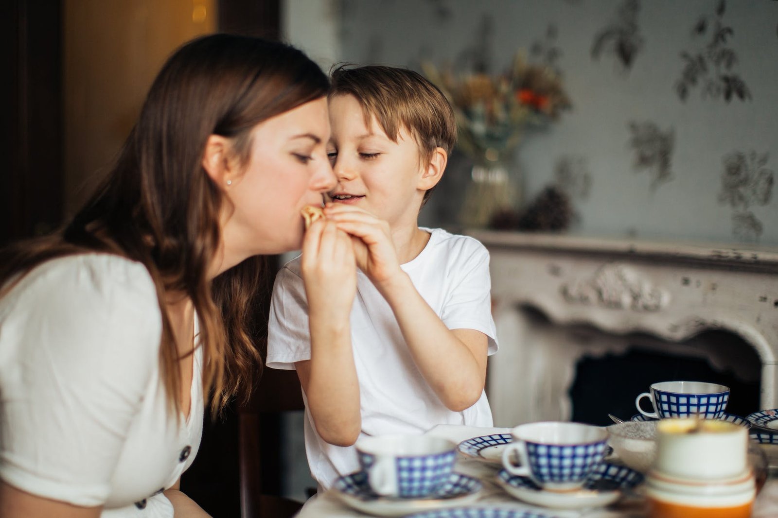 photo of boy giving food to his mom