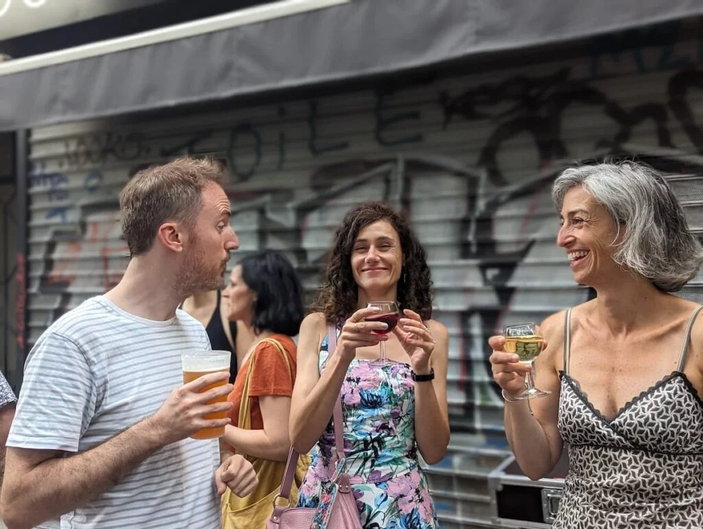 A picture of Parisians enjoying drinks in the street and having a wonderful time