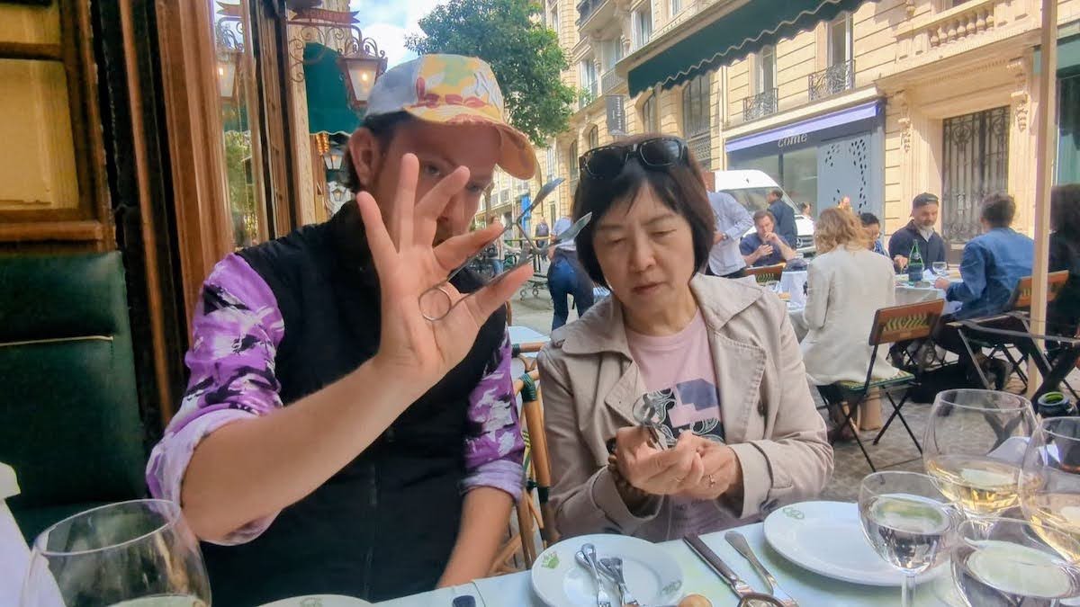 Chef Tris sharing a meal at a Paris café during a chef-led Paris food tour with Eat Like The French