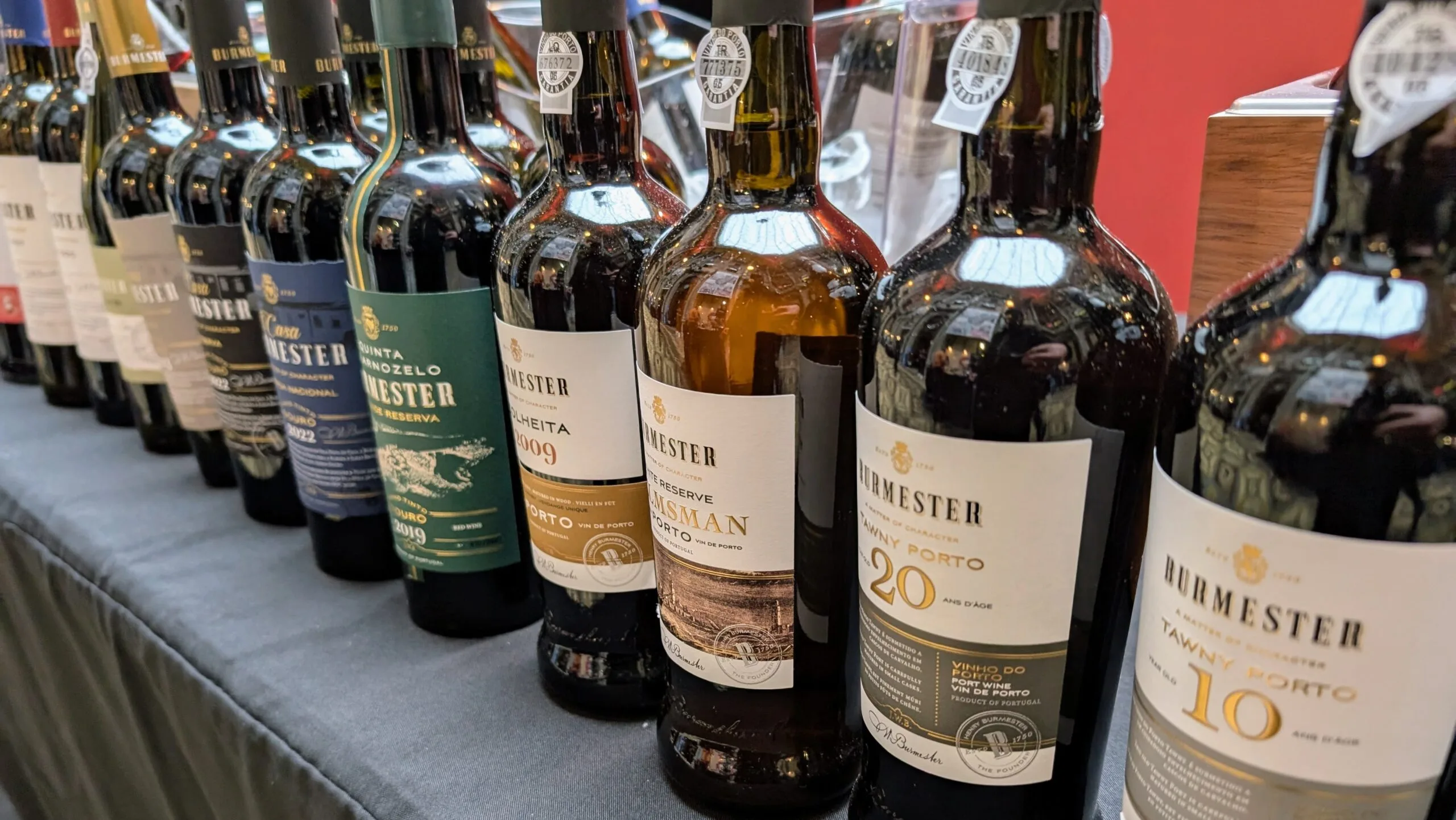 bermester wine and port A selection of Burmester Port and Douro wines displayed at a wine fair in Porto, showcasing Portugal's rich winemaking heritage.