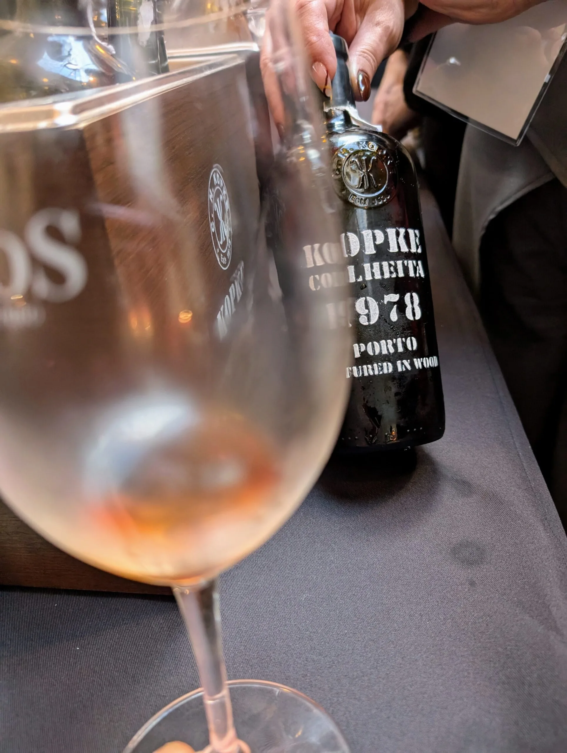 kopke 1978 port wine A rare bottle of Kopke Colheita 1978 Port being poured at a tasting event in Porto, highlighting Portugal's finest aged Port wines.