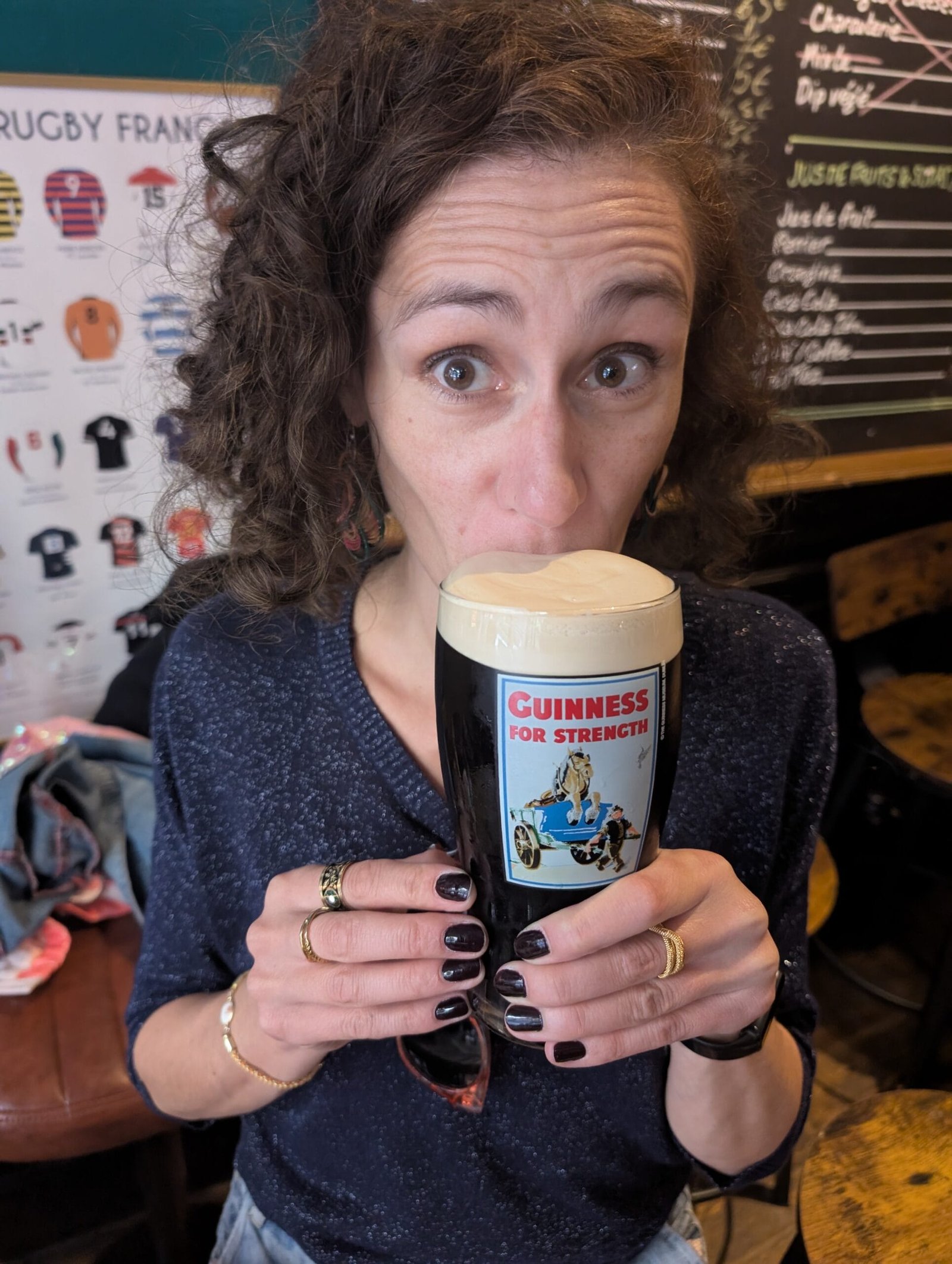 Pint of Guinness in a vintage Guinness glass at The Pub, a British pub and craft beer bar in the Marais, Paris.