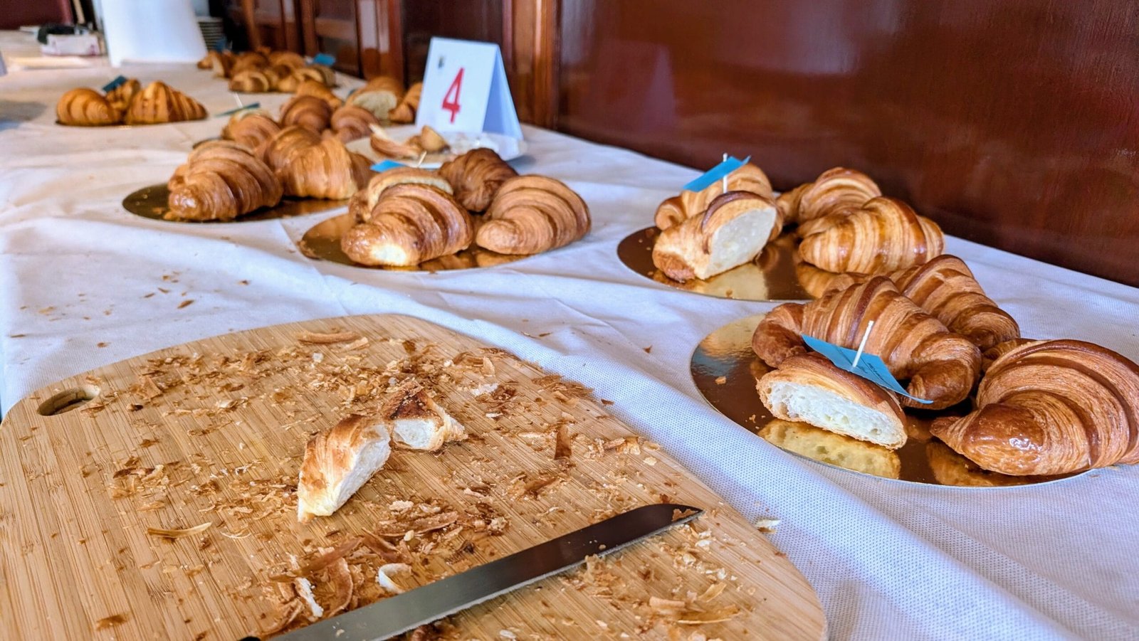 Inside the Judging Room: What It’s Really Like to Crown Paris Best Croissant 1 Judging aftermath table with cut croissant slices and crumbs after Round 1 of Paris Best Croissant competition