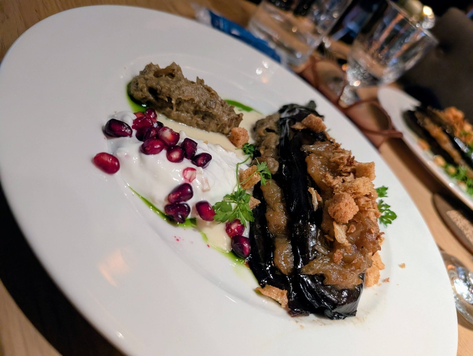 Bistro des Chefs - Aubergine Dish Vegetarian aubergine dish at Bistro des Chefs in Suresnes with pomegranate, yogurt, baba ganoush, and parsley garnish