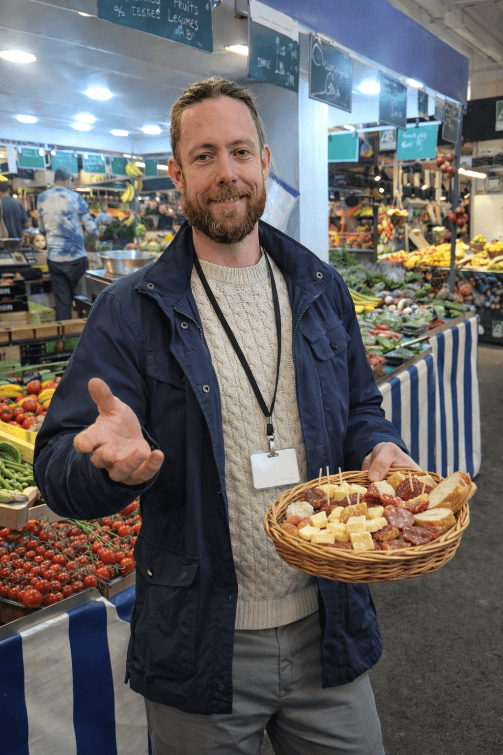 Boulogne Market Food Tour — Eat Like a Local, Not a Tourist 1 Chef Tris leading a Boulogne market food tour, offering cheese and charcuterie tastings in a lively Paris market