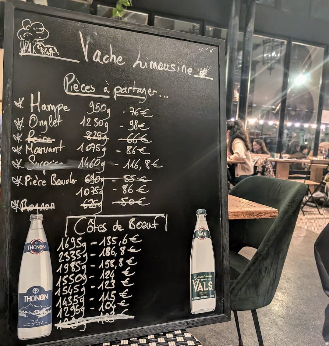 Chalkboard menu in a Paris bistro showing simple local dishes and short menu typical of authentic restaurants